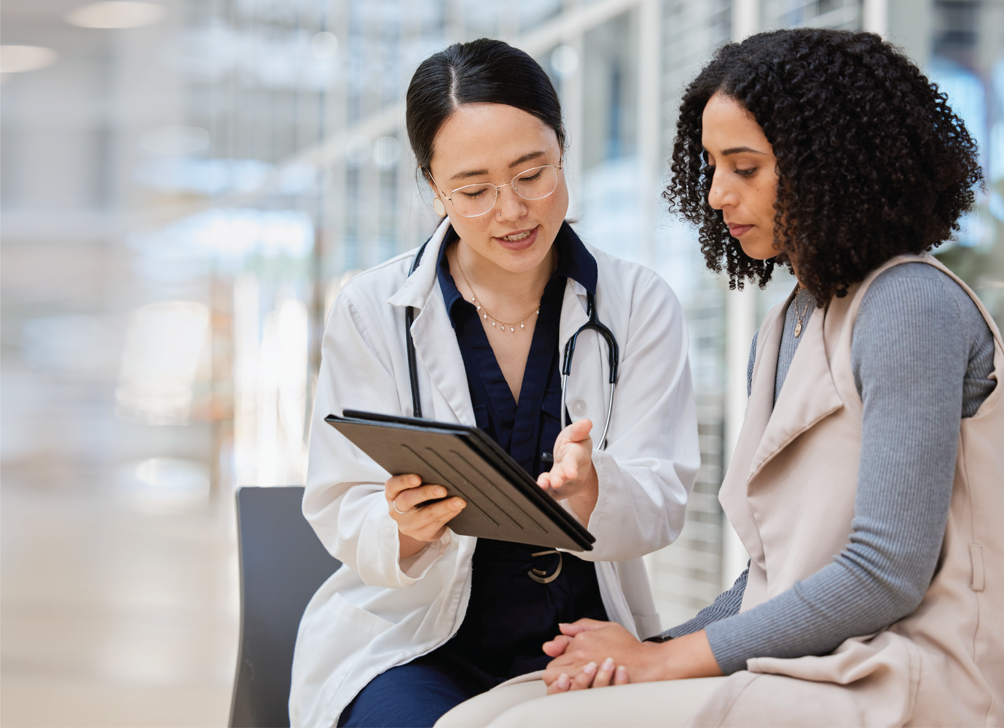 Two women, a patient and a doctor, consult.