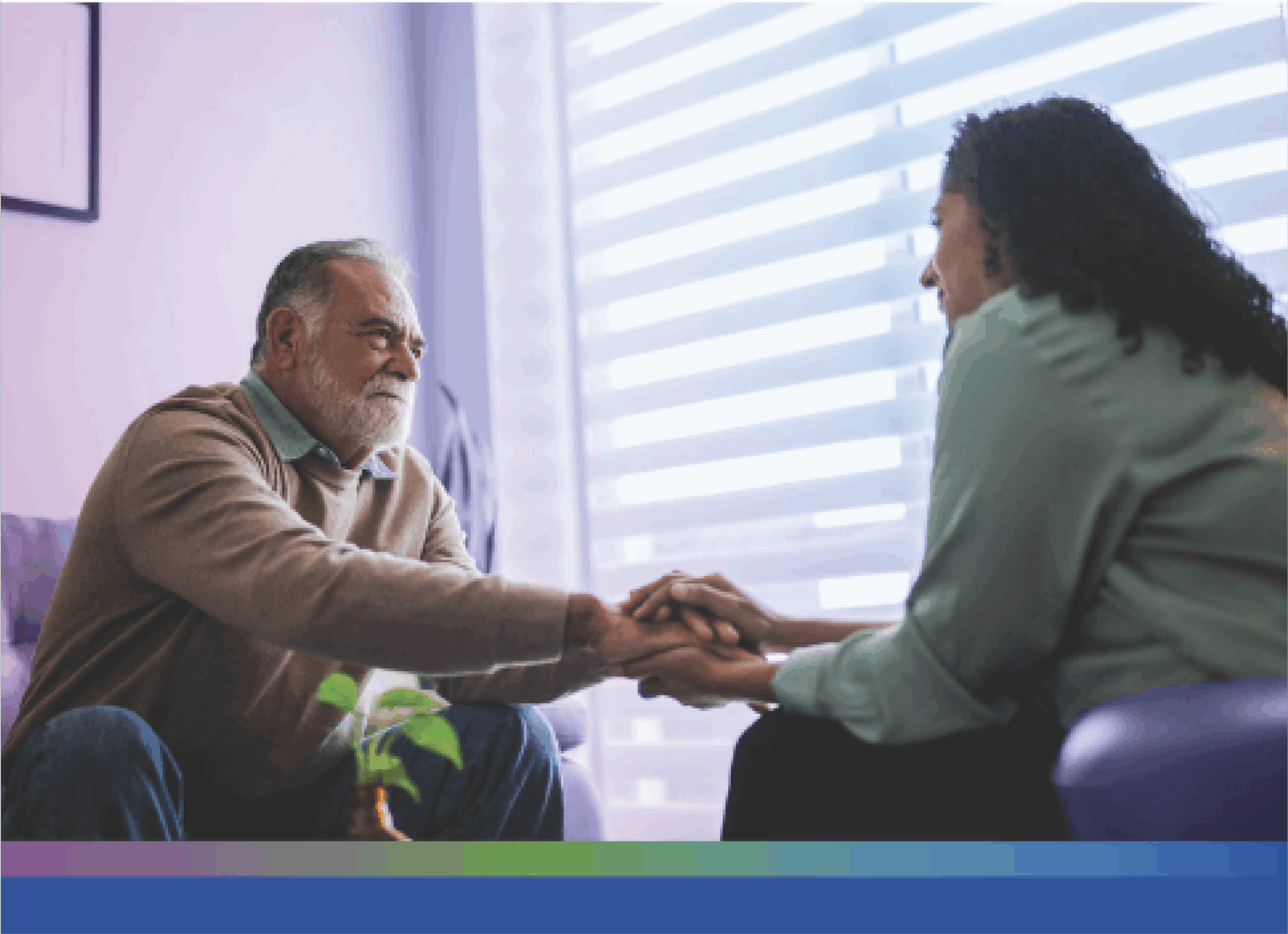 Patient has their hand embraced by a caretaker. It seems like a safe and gentle space to be in.