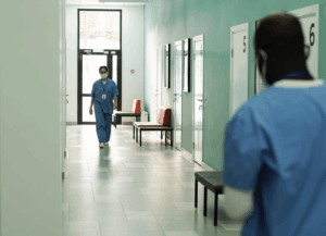 Two nurses walking in correctional facility.
