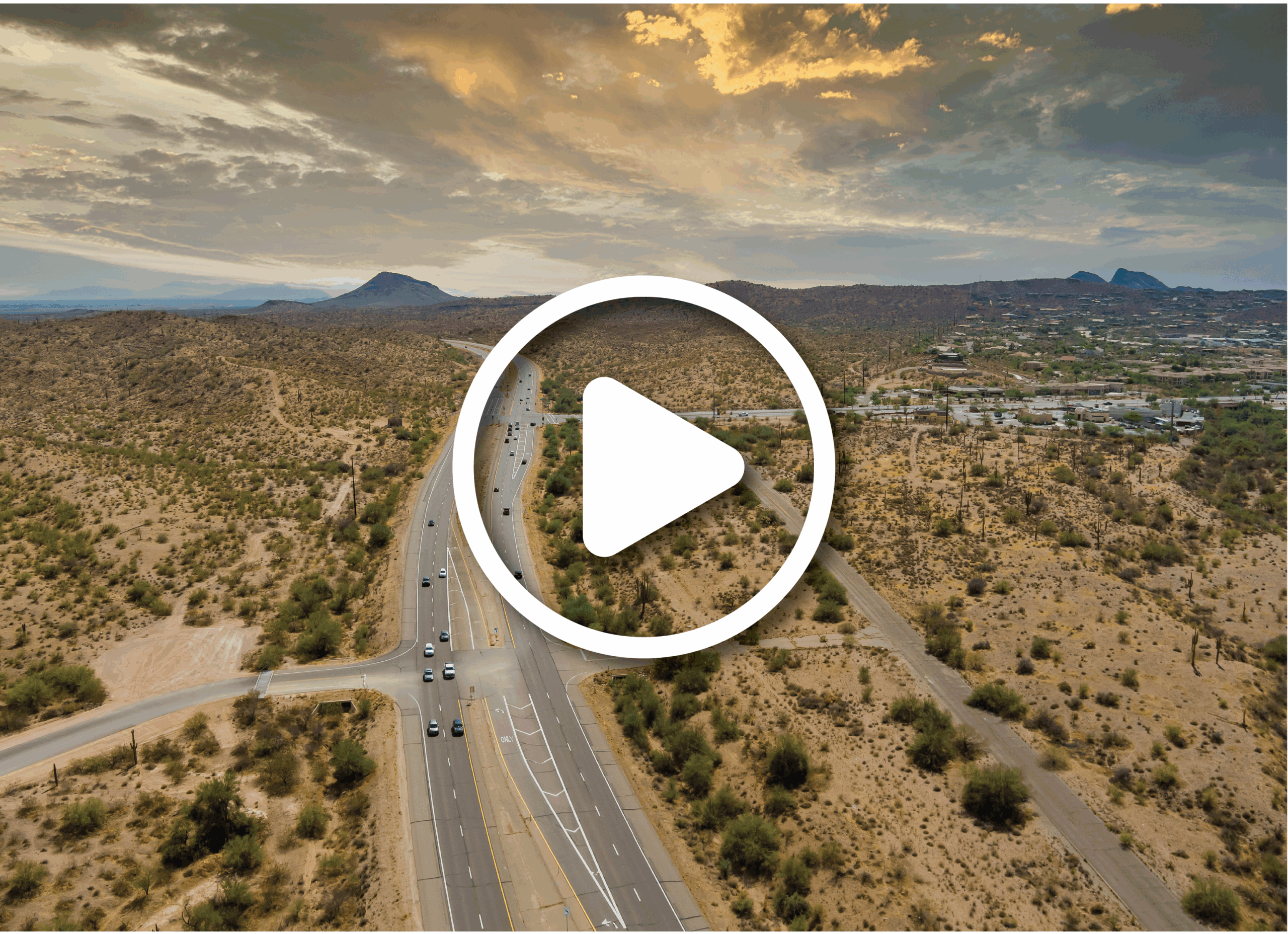 Aerial view of roads going through rural Arizona. There is a video play button overlayed on the image.