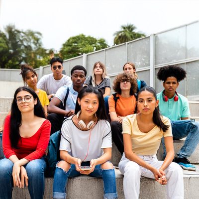 A group of young adults sitting on steps.